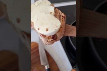 Italian food. Fresh wholegrain bread with olive oil, mozzarella, prosciutto , tomatoes and herbs.