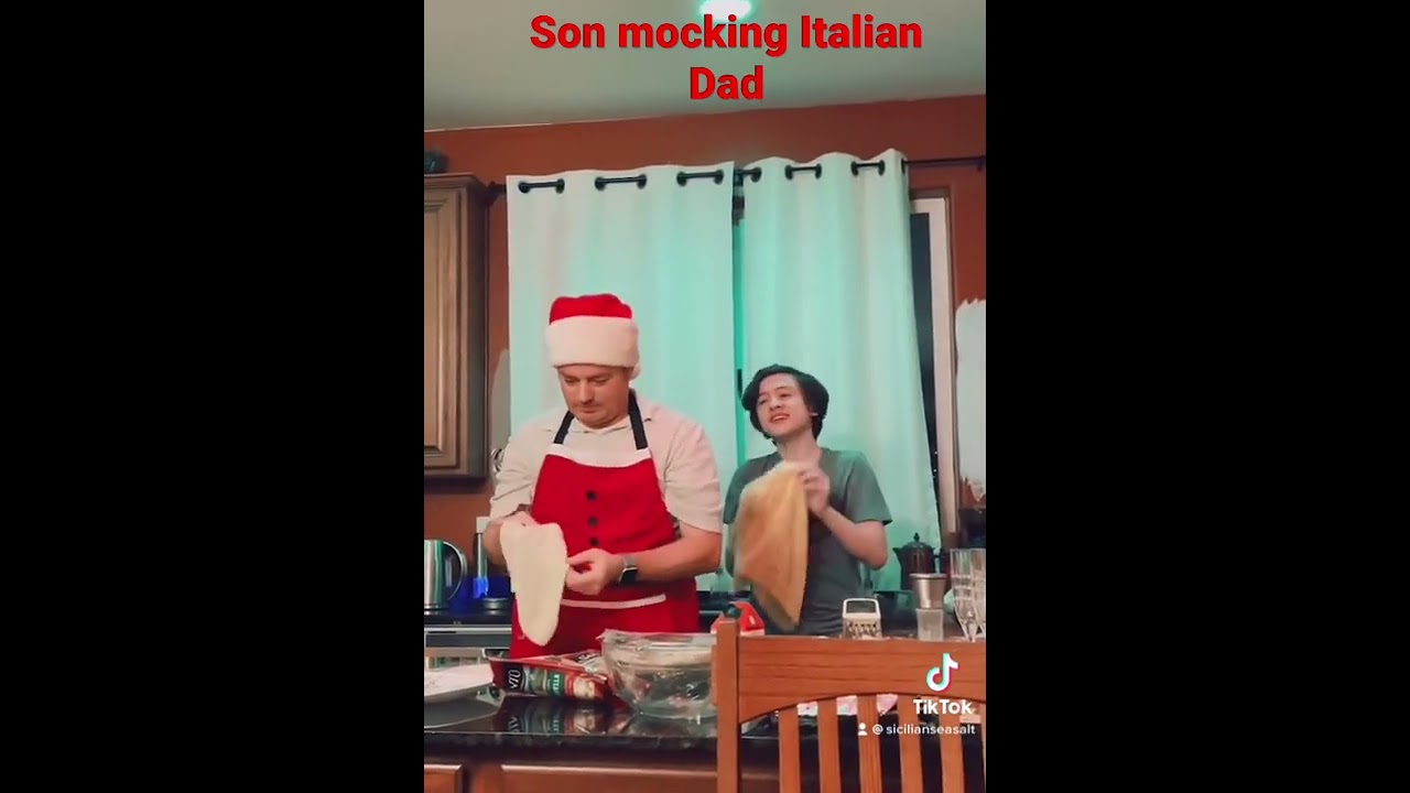 Son mocking Italian Dad with pizza making. Son mocking Italian Dad with pizza making.