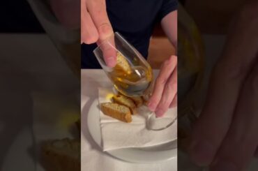 Italian cantucci with vin santo. Dipping biscotti into sweet wine. Italian dessert