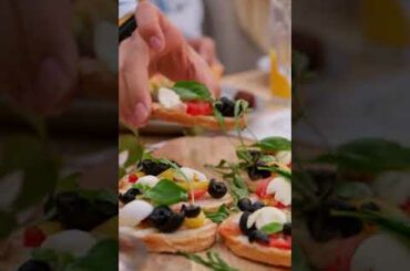 Person Picking up Food Starter from a Dining Table