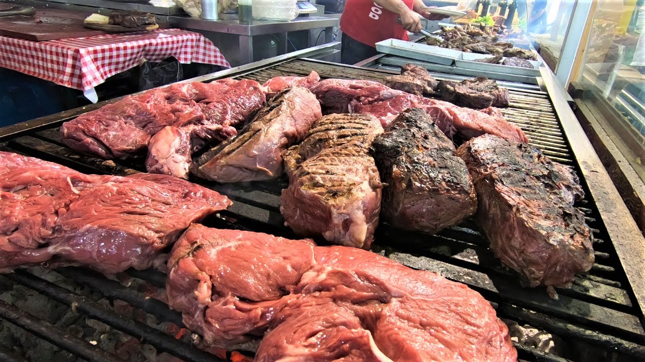 Giant 'Fiorentina' Steaks. Cutting and Grilling Huge Blocks of Beef Meat. Italy Street Food Giant 'Fiorentina' Steaks. Cutting and Grilling Huge Blocks of Beef Meat. Italy Street Food