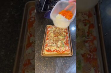 A Sicilian pizza with garden tomato sauce and fresh produce