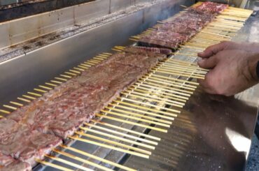 Italian Food. Cooking and Roasting the Small Skewers from Abruzzo. Arrosticini