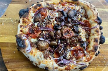 Sour dough pizza with Italian sausage, pepperoni, mushrooms, red onions and black olives.