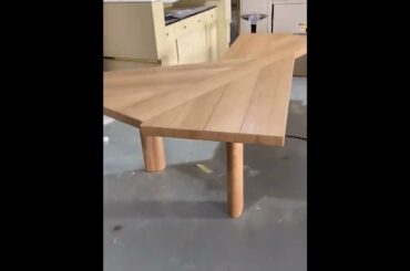 cassina golden solid wood dining table with a table top shaped like an aircraft carrier deck