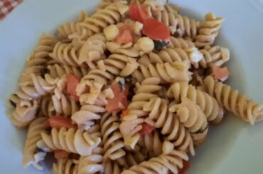 cold and light pasta with tomato, chopped almonds, flaked pecorino cheese and chopped fresh mint