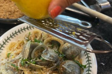 Fresh off the boat clams with calamari over spaghetti