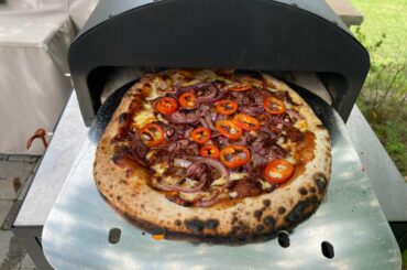 Pulled Pork Pizza with caramelized onions, jalapeños with smoked Gouda and white cheddar cheeses.