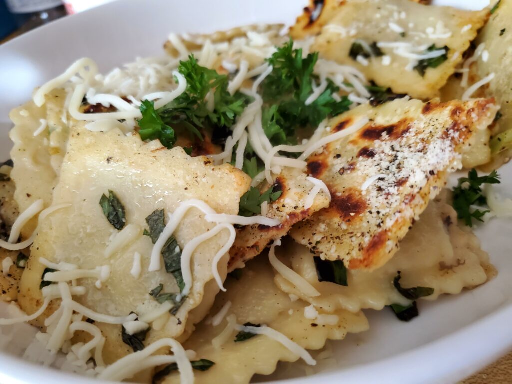 Cheese ravioli in Basil lemon butter, Parmigiano, and some parsley.