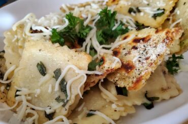 Cheese ravioli in Basil lemon butter, Parmigiano, and some parsley.