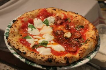 Half margherita pizza with fresh buffalo mozzarella and half marinara pizza with salami