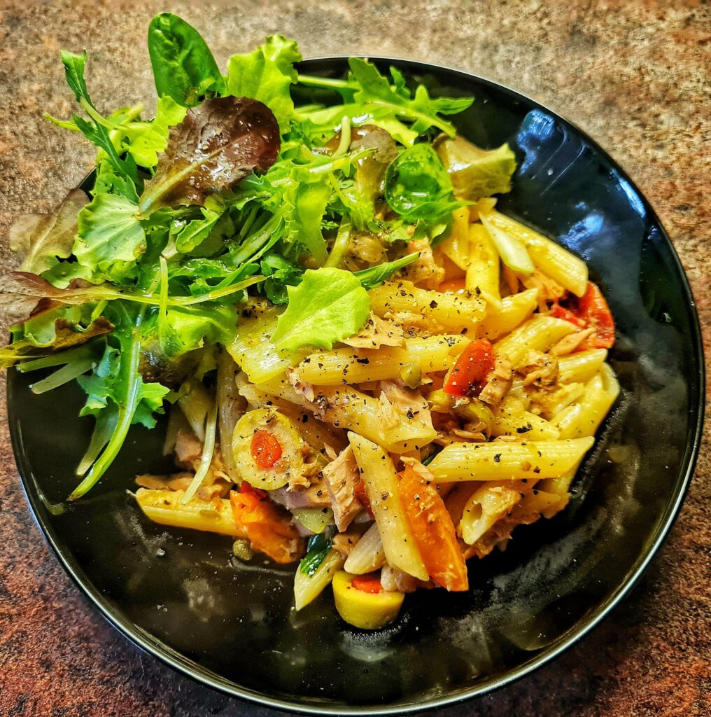 Penne with tuna, bell pepper, tomato, green olives stuffed with chili, fresh salad