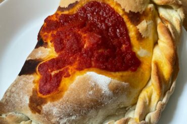 Homemade calzone - pizza dough (made with 00 flour) l filled with mozzarella, tomato sauce, parmigiano reggiano, basil, olives and mushrooms!