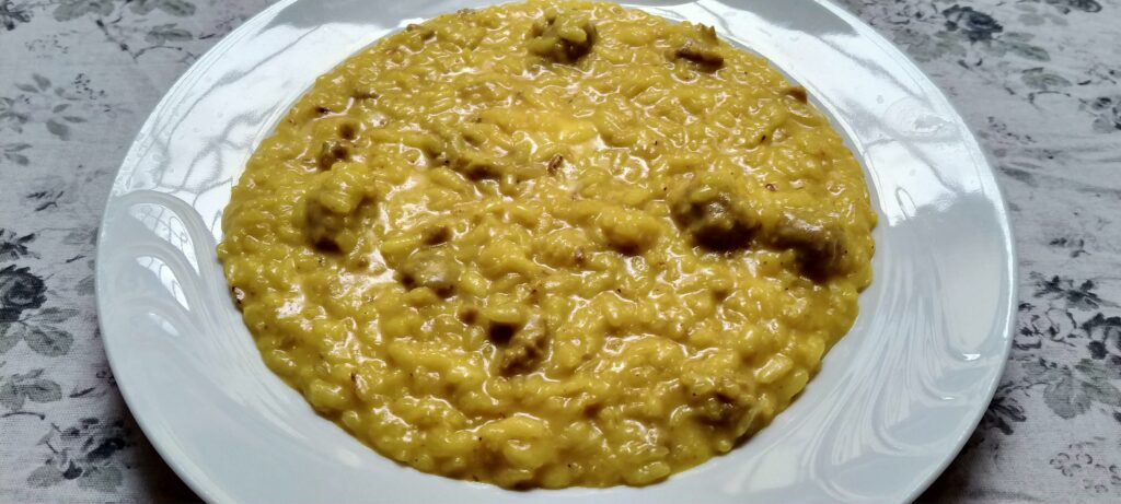 Risotto allo zafferano with mixed dried mushrooms and luganega bits