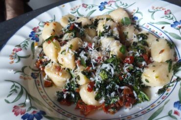 Gnocchi from scratch, with sun dried tomatoes, kale, and garlic, tossed with olive oil and salt, and topped with freshly grated parmagiano