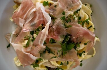 Homemade fettuccine with speck and mushrooms