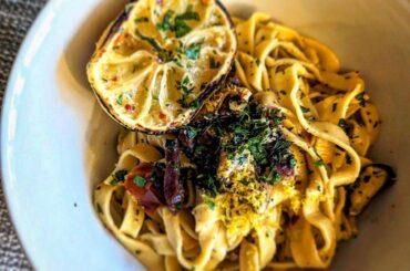 Mussels and crispy prosciutto fettuccine, cooked in a white wine, miso, and charred lemon sauce