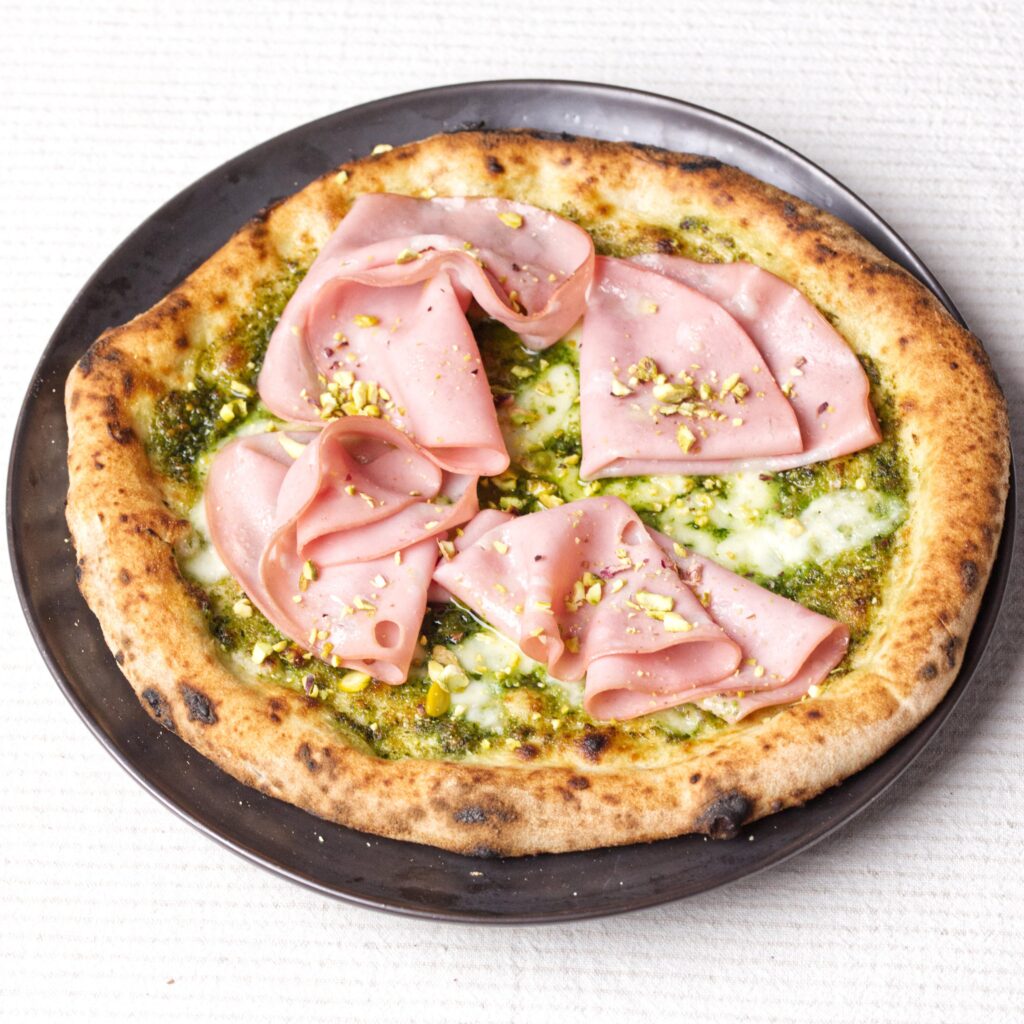 Pizza with Pistachio Pesto, Fior di Latte and Mortadella. Made with 15% Whole Wheat Poolish.
