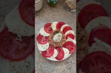Fresh sunmer food: salmon and avocado tartare with tomatoes and mozzarella