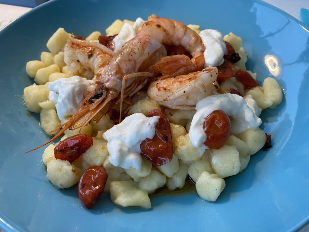 Gnocchi with caramelised tomatoes, burrata and prawns