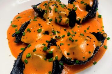 Squid ink lobster tortelloni in a bisque sauce