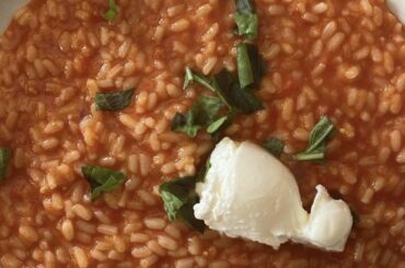 Risotto with cherry tomatoes soup, basil and burrata