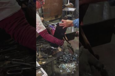 Italian Glass Artisan making a Murano Glass Flower Vase In Murano, Italy.