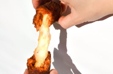 Homemade supplì - fried tomato rice balls stuffed with mozzarella