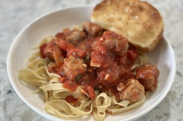 Fresh pasta with sweet Italian sausage and a homemade tomato-basil sauce (and garlic bread)