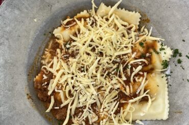 Pumpkin and cheese ravioli, with lots of cheese on the surface, food made in a beautiful vineyard