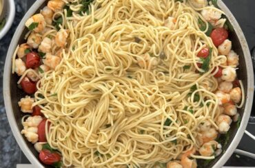 Homemade egg spaghetti with shrimp and cherry tomatoes