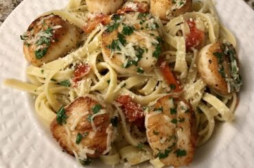 I made fettuccine with seared scallops, grated garlic, cherry tomatoes, parsley and parmesan cheese