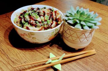 Ramen with fried pork, sesame seeds, sushi sauce, garlic, and green onion.