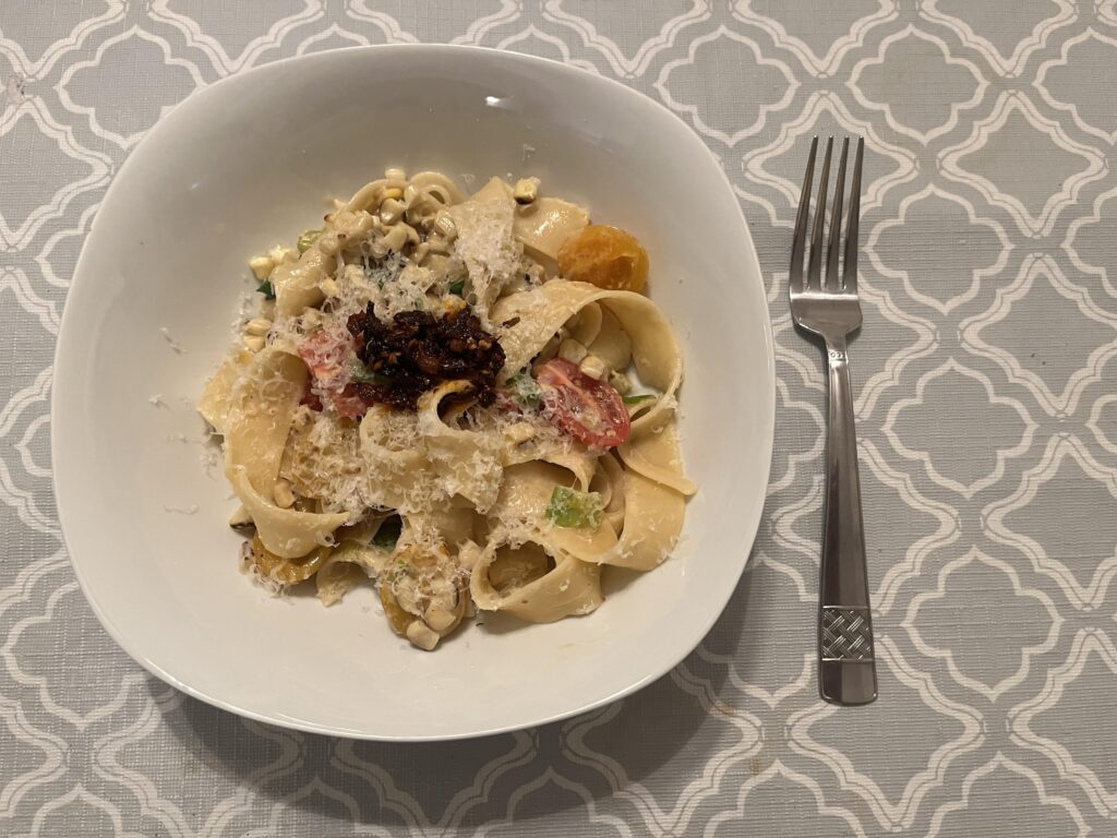 Tagliatelle in a charred corn, scallion and tomato sauce