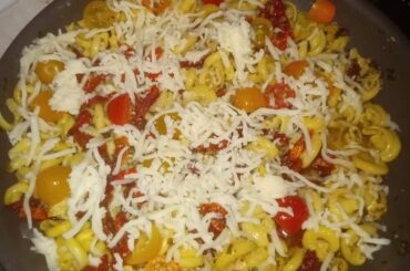 Pasta I made with garlic pesto sauce, cherry tomatoes, sundried tomatoes, and Parmesan cheese