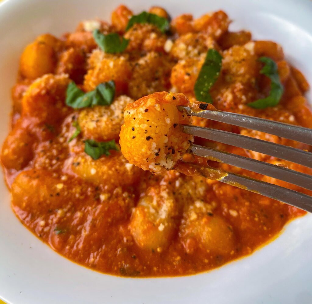 Gnocchi with Shrimps, Red Sauce and Basil.