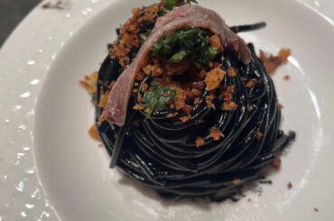 Homemade spaghetti with squid ink, toasted spicy breadcrumbs, crushed mint & parsley and an anchovie