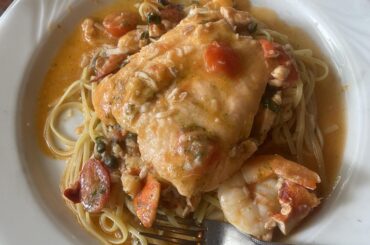 Linguine in a cherry tomato pesto sauce with salmon, peas, jumbo shrimp