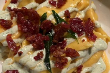 Agnolotti filles with sweetpotato and ricotta served with a goatcheese and sage cream and finished with some fried parm and sage.