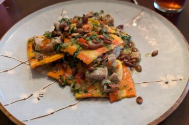 Ravioli do Zuca with toasted pepitos, sausage and cilantro