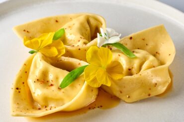 Tortelloni filled with ricotta, giant tiger prawns, garlic confit, shallots, parmesan and parsley. Served with clarified butter infused with chili and sage.