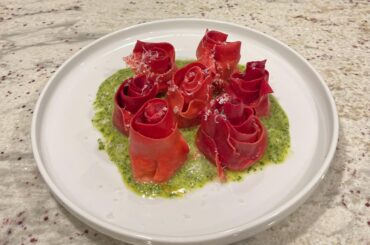 Ravioli Roses— filling is roasted chicken and ricotta, sitting in some pesto sauce.