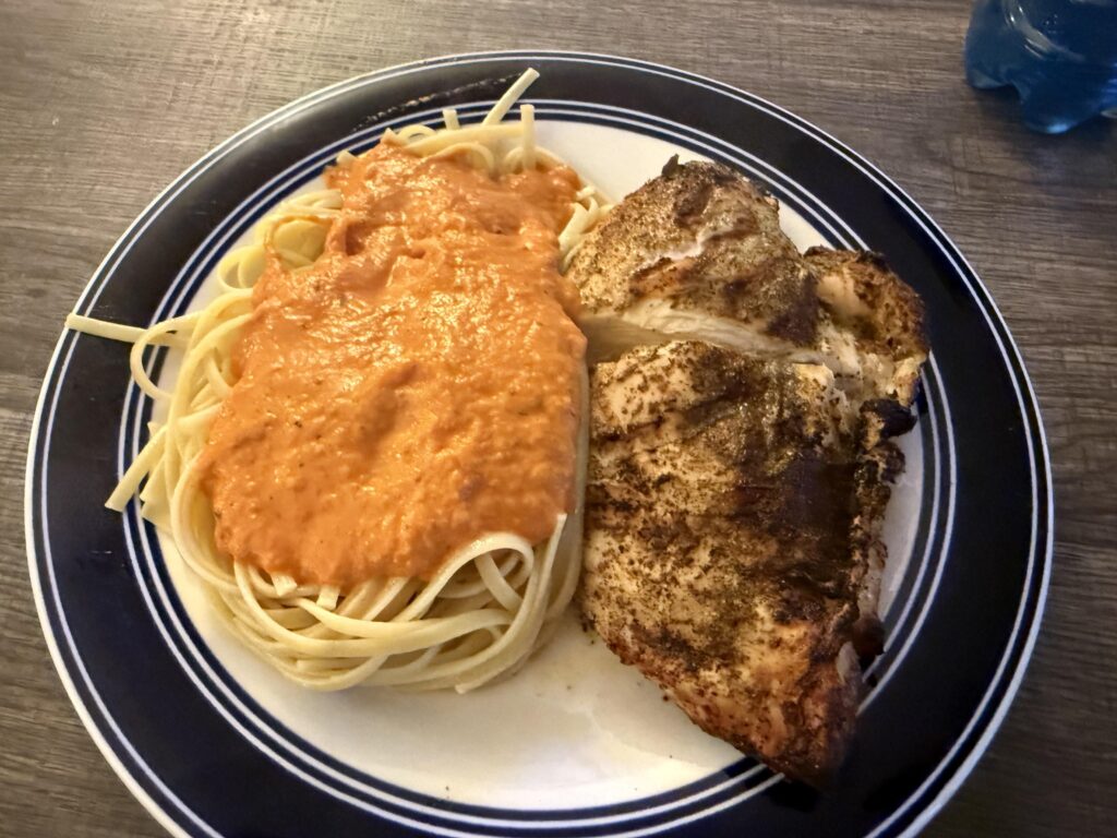 Homemade vodka sauce on grilled chicken and linguine.