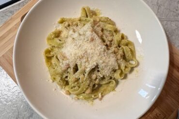 homemade pasta with pesto and pine nuts