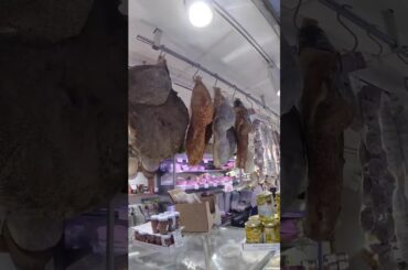 Hanged Italian Prosciutto Hams, Cheese and More Food. Italy Food Market
