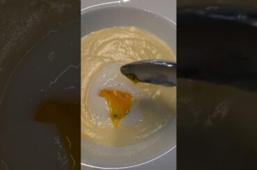 Soft Egg into Melted Cheese Fondue. Italian Food from Alba, Langhe