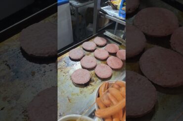 Cooking Big Italian Burgers on Grill. Italy Food Fair