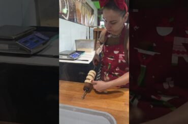 Rolling up and cooking the Kurtos Kalacs sweets from Hungary and Romania