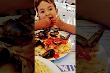 My 4 year-old enjoying a plate of mussels in Italy