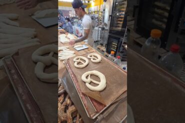 Making and Baking Big German Pretzels. Italy Food Festival